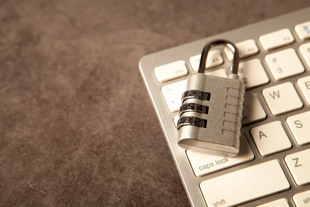 A padlock rests on a computer keyboard.